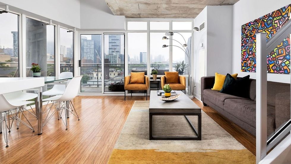 This two-storey corner loft with a wrap-around balcony is on sale for ...