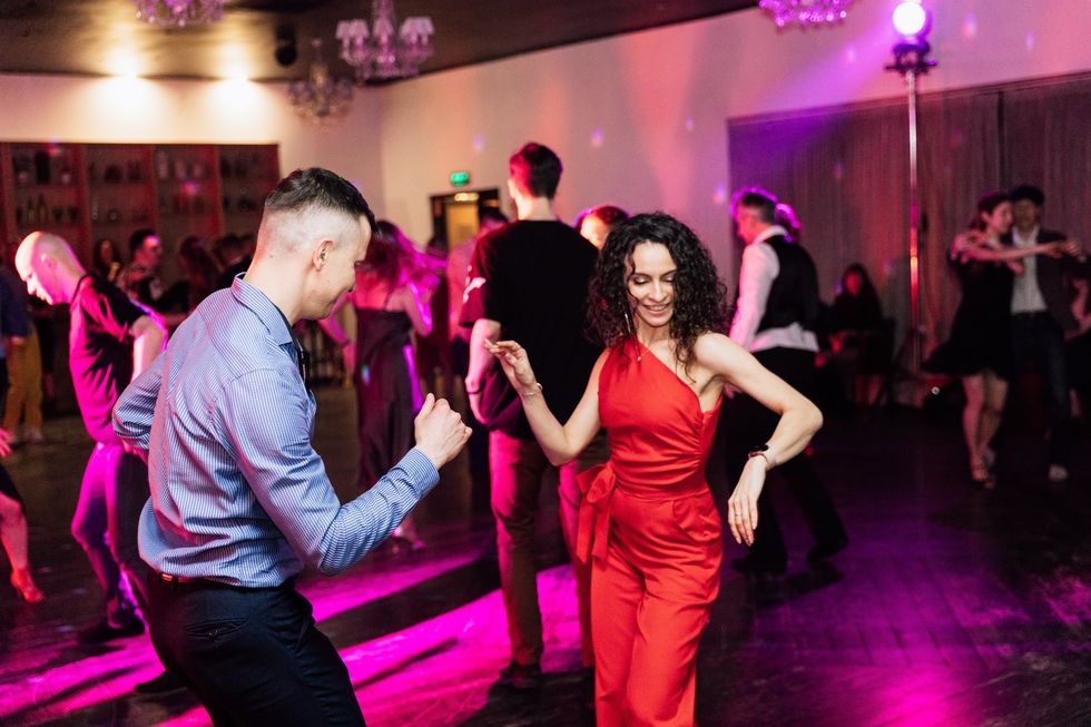man and woman salsa dancing