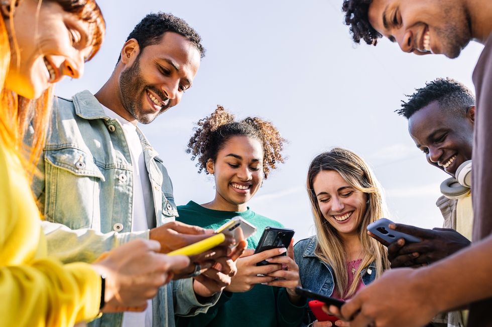 Calgary group chat Group of young people looking at their phones