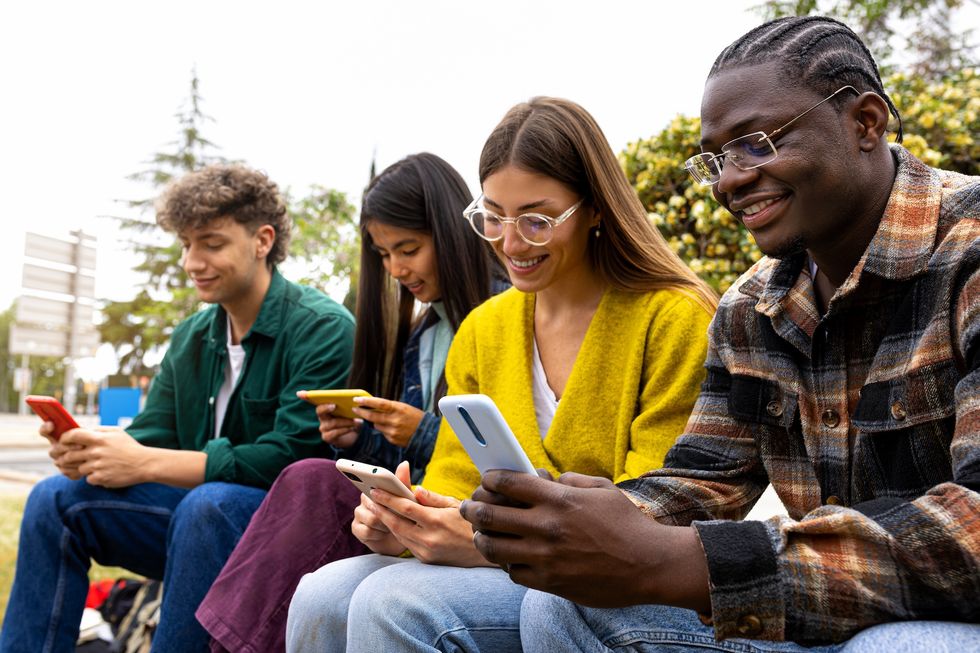 Group of young adults texting each other