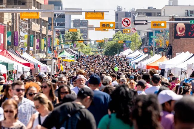 People gathering on 4th St. SW in Calgary, Alta. for the Lilac Festival.