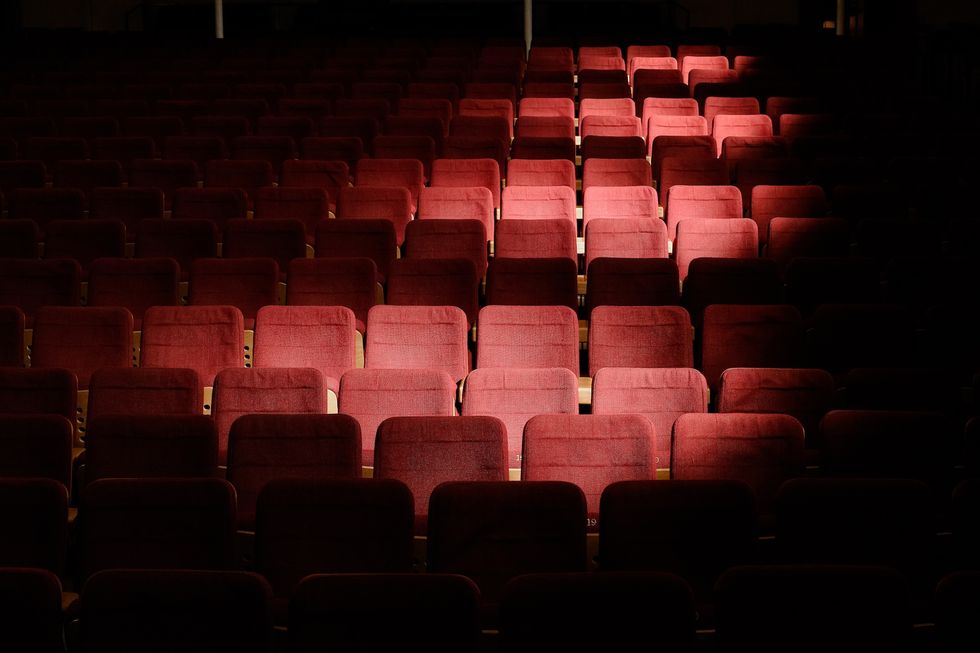 Old school movie theatre with spotlight on seats