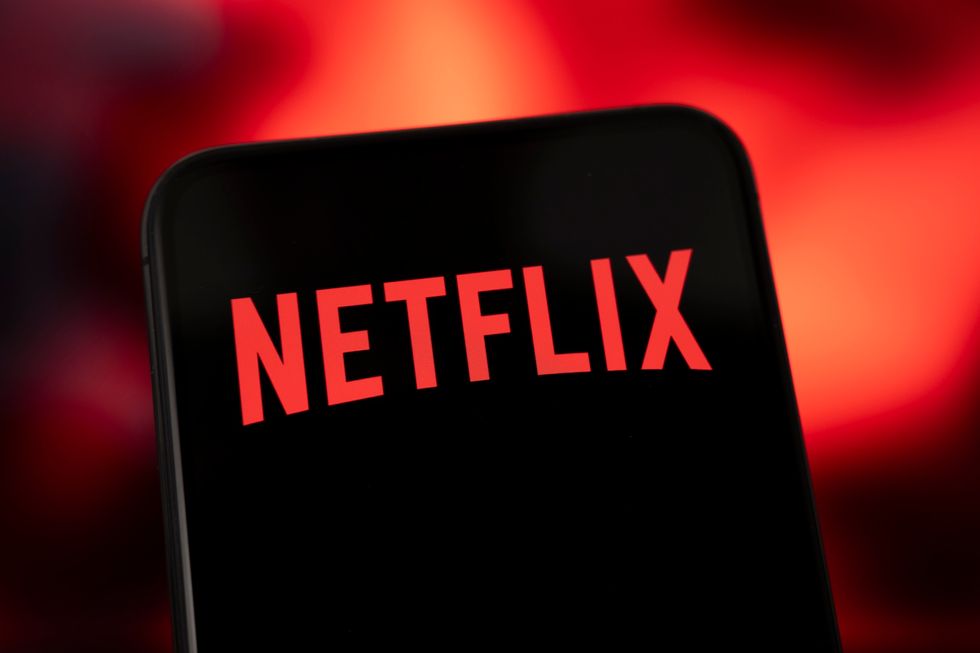 Netflix logo displayed on a smartphone screen with red gradient background.