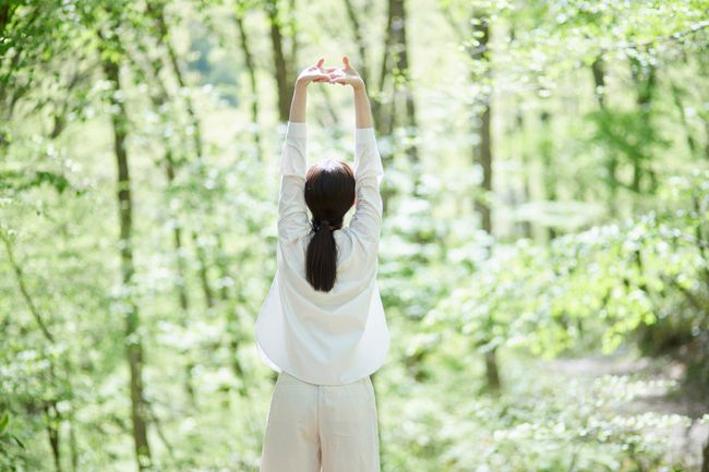 woman enjoying forest bathing in nature