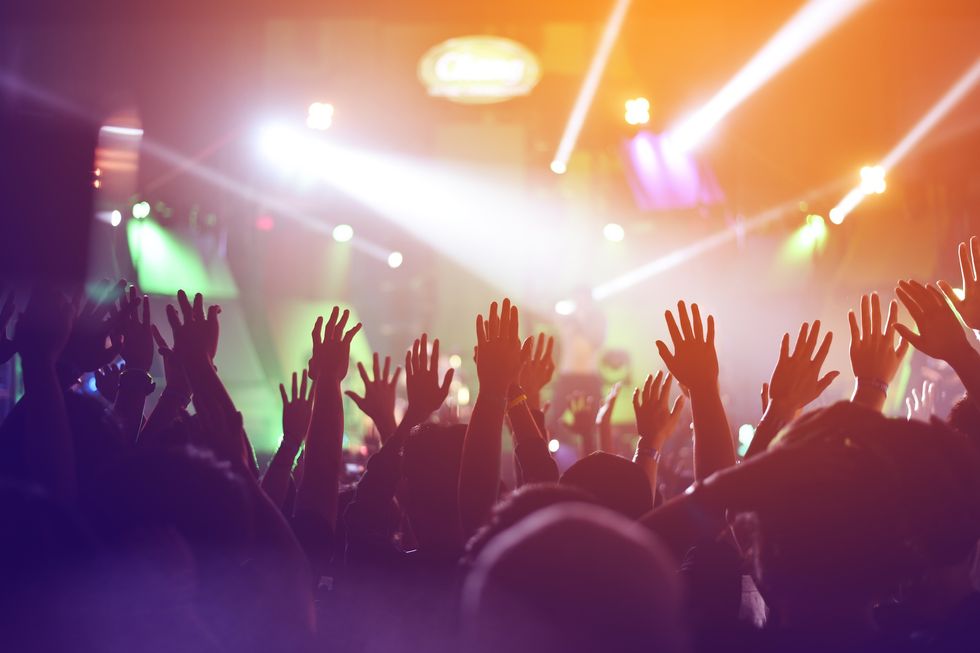 silhouette of fun concert party rock disco light background.