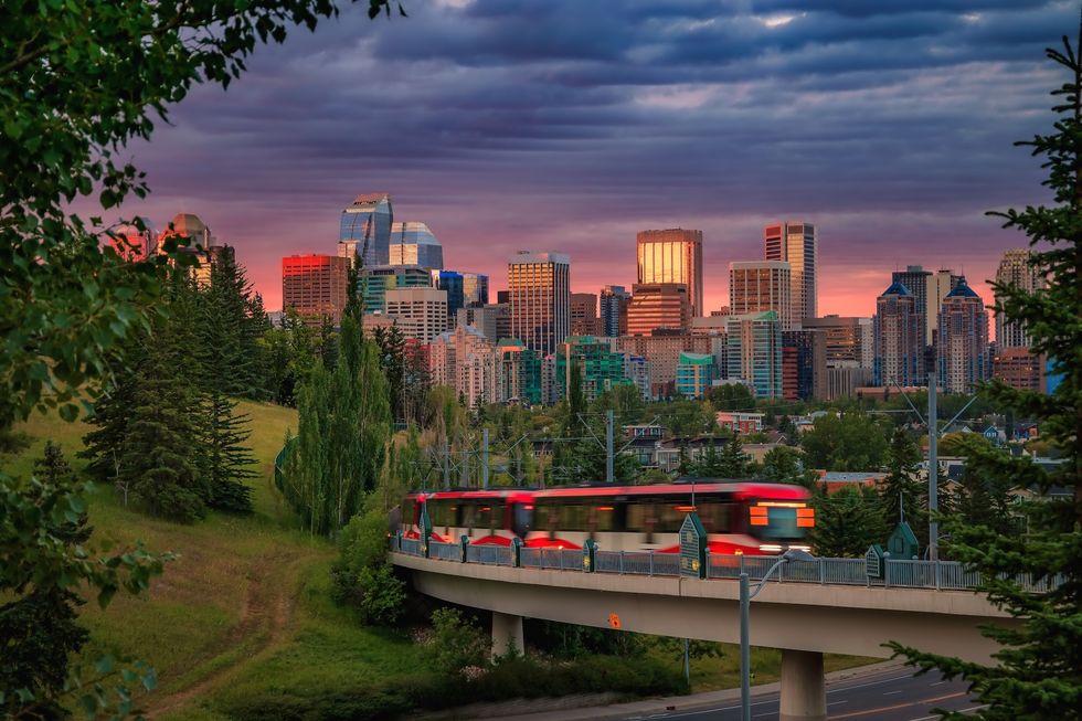 A city train commuting under a cloudy sunrise sky in Calgary A city train commuting under a cloudy sunrise sky in Calgary
