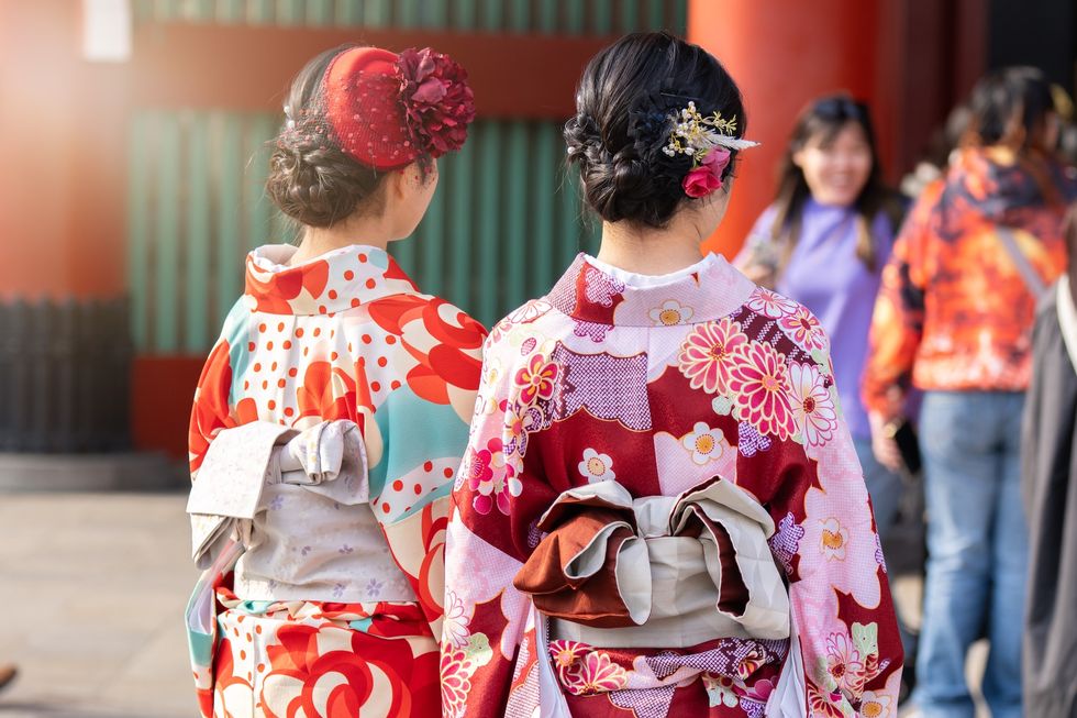 Japanese festival Young girl wearing Japanese kimono standing in front of Sensoji Temple in Tokyo, Japan. Kimono is a Japanese traditional garment. The word