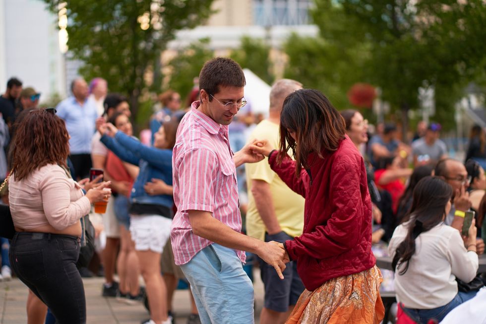 People dancing Cheerful diverse crowd of people dancing and enjoying a live music concert at an outdoor summer festival. 07.02.2023 - Calgary, Canada