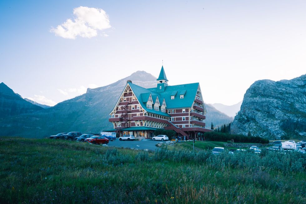 Prince of Wales Hotel, A Historic hotel nestled in the mountains with a teal roof and nature around. Waterton, AB