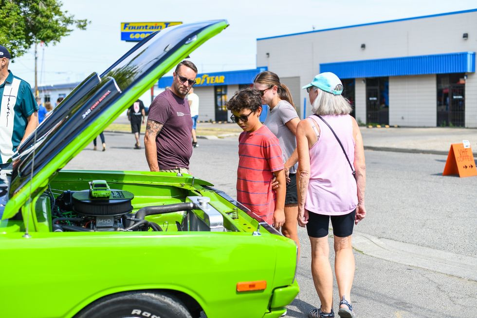 Crowd looking at hot rods showcase during the Tango 2 Echo Festival