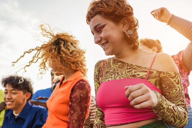 Happy young people dancing outdoor at festival event