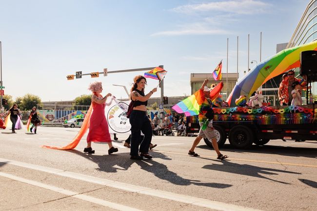 Calgary, Alberta, Canada, August 31 2025 - Participants march with rainbow flags during the Calgary Pride Parade, celebrating LGBTQ+ pride, diversity, and inclusion.