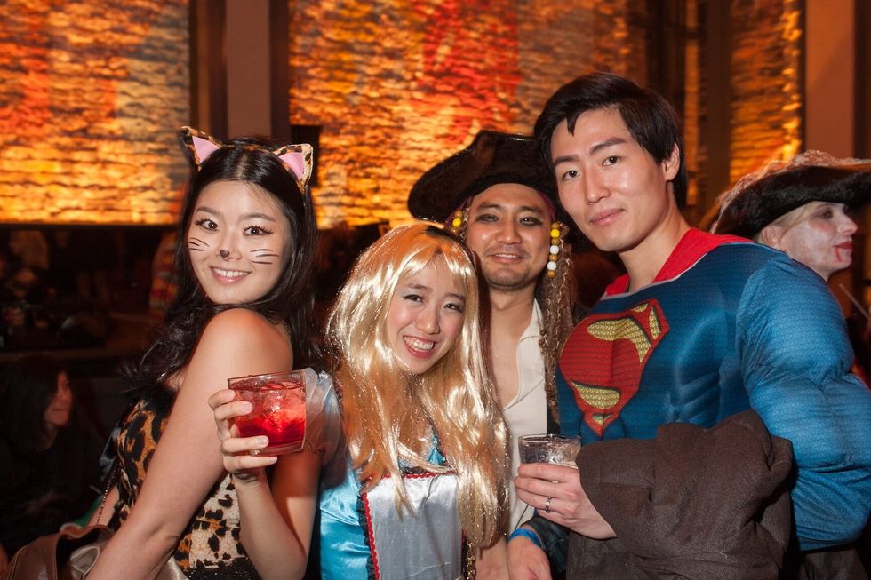 Guests in mascarade costumes posing at The Fashion Party during Halloween event