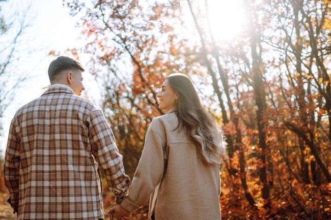 Stylish couple walking and enjoying autumn weather. People, lifestyle, relaxation and vacations concept. Autumn Fashion, style concept.