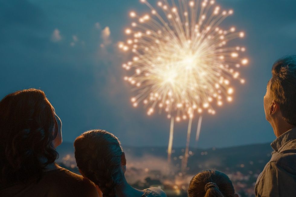 Silhouetted Family Watching Fireworks at Dusk