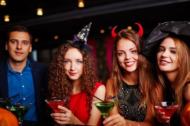 Young people drinking martini at Halloween eve