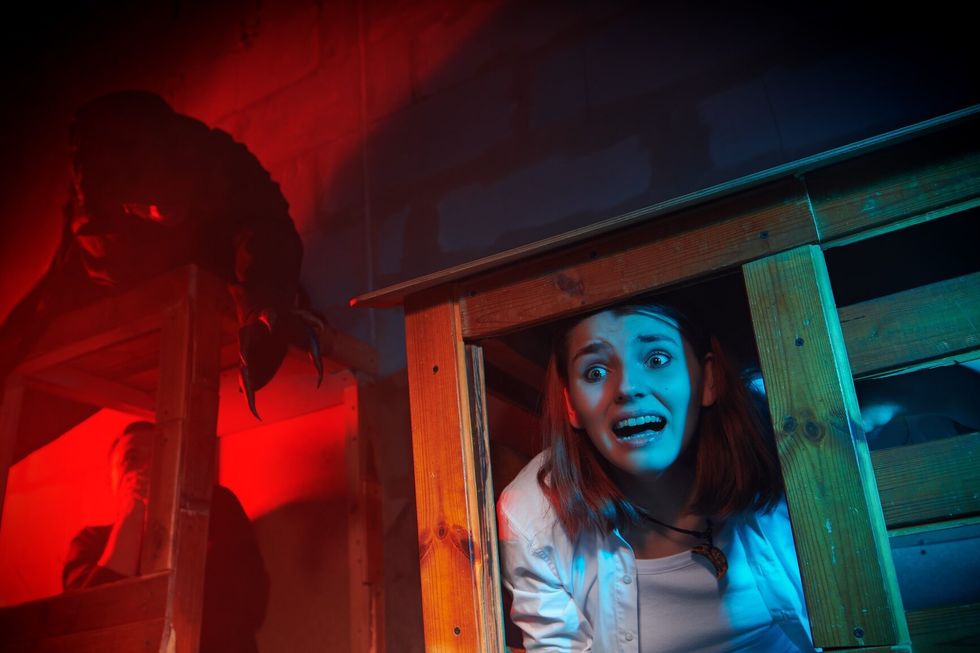 Haunted houuse Horror, thriller. The girl is trapped in a wooden cage and screams in horror and asks for help. Halloween.