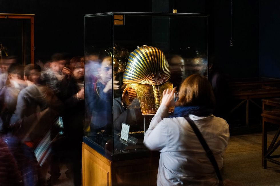 Person looking at King Tut in an exhibit