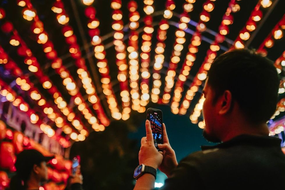 Man taking photos at Pumpkins After Dark